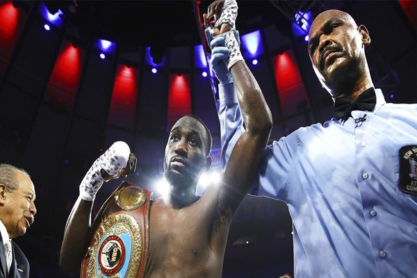 Terence Crawford wins by stoppage over Amir Khan in fight marred by low blow